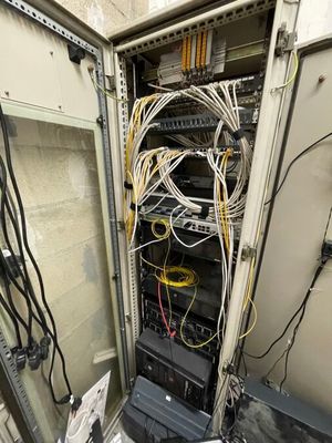 many wires and wires in a cabinet in a room