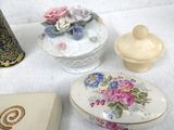 a small box with a flower design on it next to a smaller box with a flower design on it