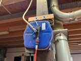 a blue box attached to a pole with a red hose