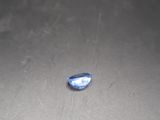 a blue stone sitting on top of a black table