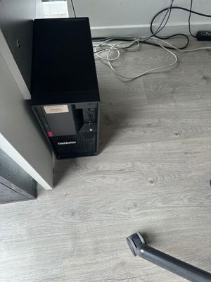 a black and silver vacuum on the floor next to a wall