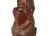 wooden statue of a woman holding a heart on a white background