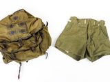 un short militaire et un sac à dos posés sur une surface blanche