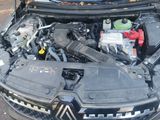 the engine of a car with its hood open on the street