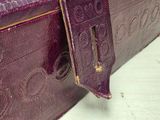 a close up of a purple suitcase on a table