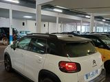 many cars parked in a parking lot in a parking garage