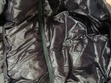 a black jacket with a zipper on it on the floor