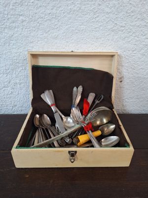 a wooden box with silverware in it on a table