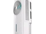 a white air conditioner sitting on top of a white table