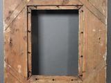 an old wooden picture frame with a hole in the middle of it