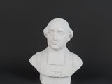 a white busturine of a man with a hat on his head