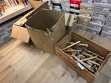 a box full of screws sitting on the floor next to a box of screws