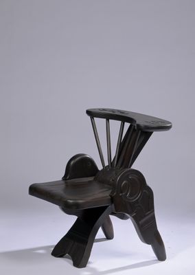 an image of a chair made out of wood with a seat made out of metal
