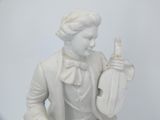 a white statue of a man holding a guitar
