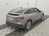 the rear end of a silver audi suv parked in a garage