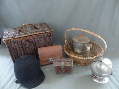un panier, un chapeau, une théière, une bouilloire et d'autres objets posés sur une table