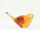 yellow glass bird sculpture on white surface with white background