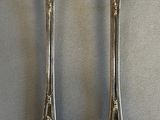 two spoons that are sitting on a table
