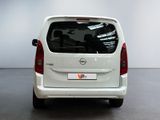 the back end of a white van parked in a room