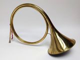 a brass trumpet with a red handle on a white background
