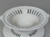 a white bowl that is on a saucer on a saucer
