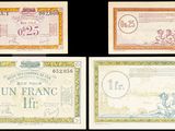 quatre billets de banque différents, chacun arborant un motif distinct sur fond noir