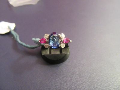a necklace with a blue stone and pink stones on it