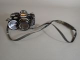 a camera with a strap on it sitting on a table