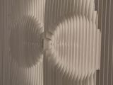 a close up of a sculpture made out of paper on a wall