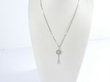 silver necklace with a cross pendant and a chain on a mannequin head
