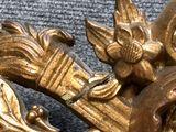 a close up of a gold clock with a bird on it