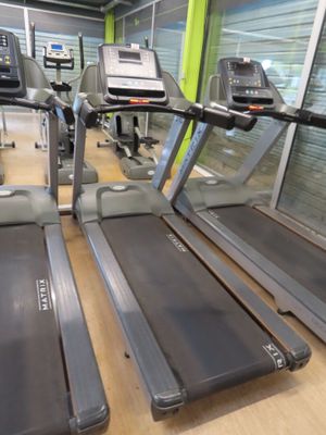 row of treads in a gym room with windows and a television