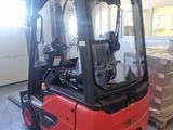 a red forklift truck parked in a warehouse