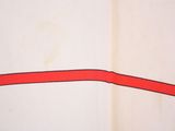 a red strip on the wall of a bathroom
