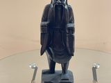a statue of a man sitting on a glass table