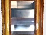 a picture of a gold framed mirror on the wall