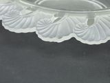 a clear glass bowl with a flower design on it