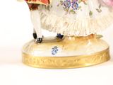 a figurine of a man and a woman on a horse