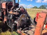 a tractor that is sitting in the grass