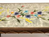 a table with a painted flower design on it