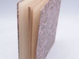 a close up of a book on a white surface