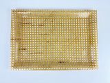 an image of a square gold tray with holes on it