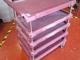 a pink cart that is sitting on a red floor
