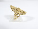 a close up of a gold and diamond ring on a white surface