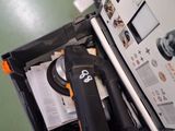 an open suitcase with a laptop and other items in it