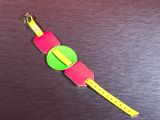 a pink and green watch with a yellow band on it
