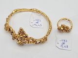 an image of a gold bracelet and ring with a price tag