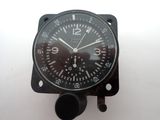a black clock on a white surface with a white background