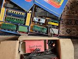a box full of toy trains sitting on the floor