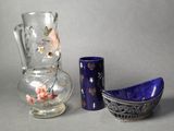 two vases and a bowl sitting next to each other on a table